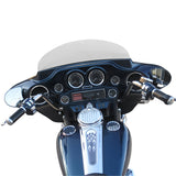 Motorcycle dashboard with chrome accents, gauges, and black handlebars