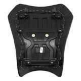 Underside of a black motorcycle seat with plastic base and mounting points